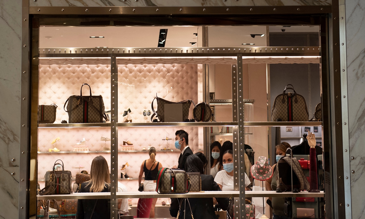 People wear masks while visiting a Gucci store as the city adapted to the COVID-19 pandemic September 13, 2020, in Las Vegas, US. 
Photo: AFP