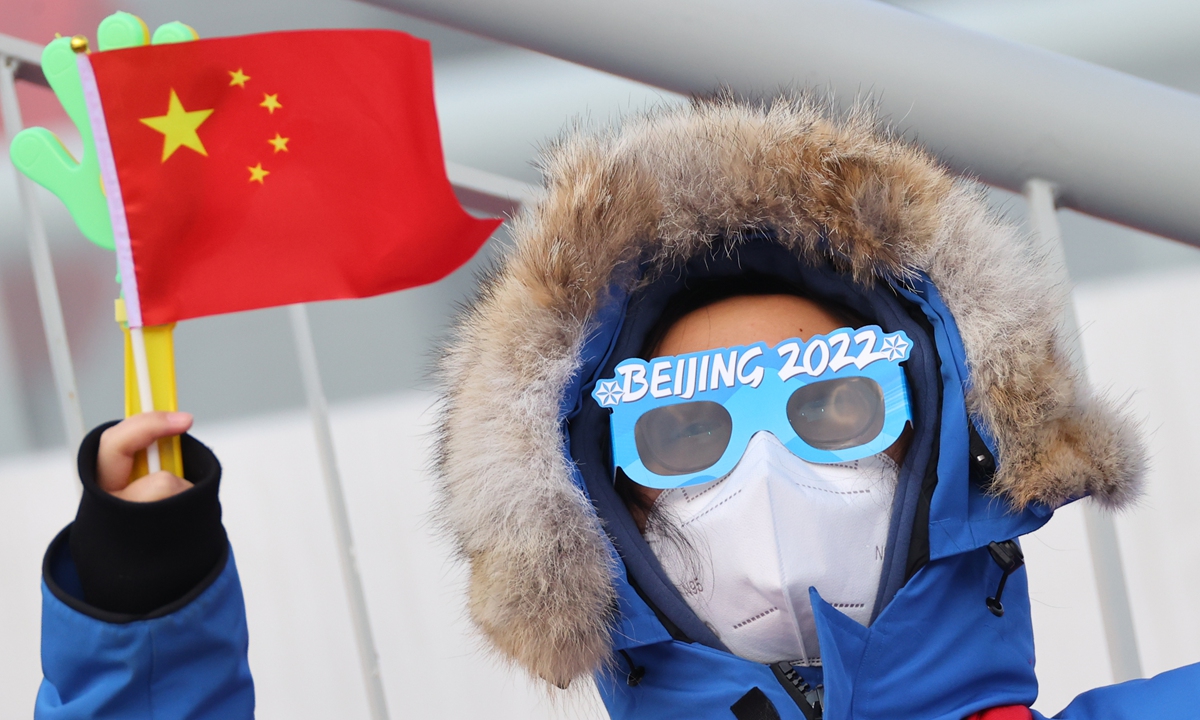 A spectator watches a competition of individual Gundersen Normal Hill/10km at the National Ski Jumping Center in Zhangjiakou, North China's Hebei Province on February 9, 2022. Photo: IC