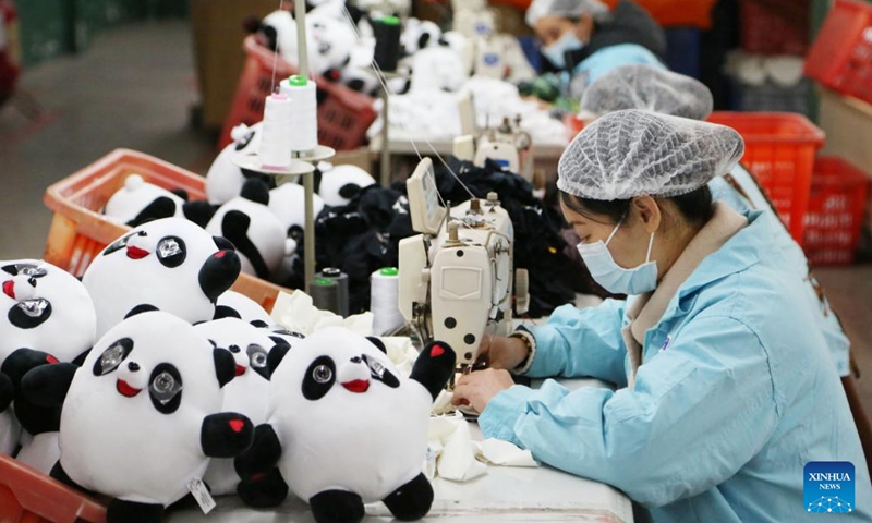 Workers produce Bing Dwen Dwen merchandise at a toy factory in Jinjiang City, southeast China's Fujian Province, Feb. 9, 2022. Bing Dwen Dwen, the mascot for the Beijing 2022 Olympic Winter Games, has recently become a smash hit. A licensed manufacturer in Jinjiang has resumed the production of Bing Dwen Dwen merchandise ahead of schedule to ensure adequate supply for the market.(Photo: Xinhua)
