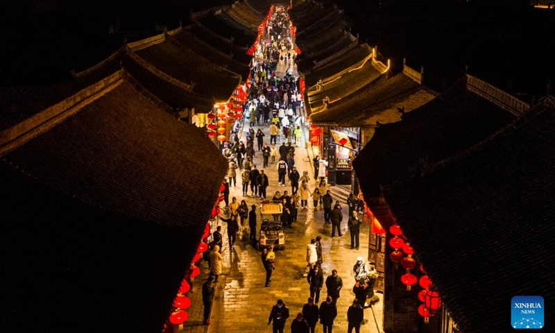 An aerial photo shows a view of the ancient town of Pingyao during the Spring Festival in Jinzhong City, north China's Shanxi Province, Feb. 7, 2022. With a history of over 2,800 years, Pingyao was named a World Heritage Site by UNESCO in 1997. It is best known for its nearly intact Ming Dynasty (1368-1644) city walls and well-preserved architectures, and is a popular destination for Chinese tourists and foreigners.  (Xinhua)