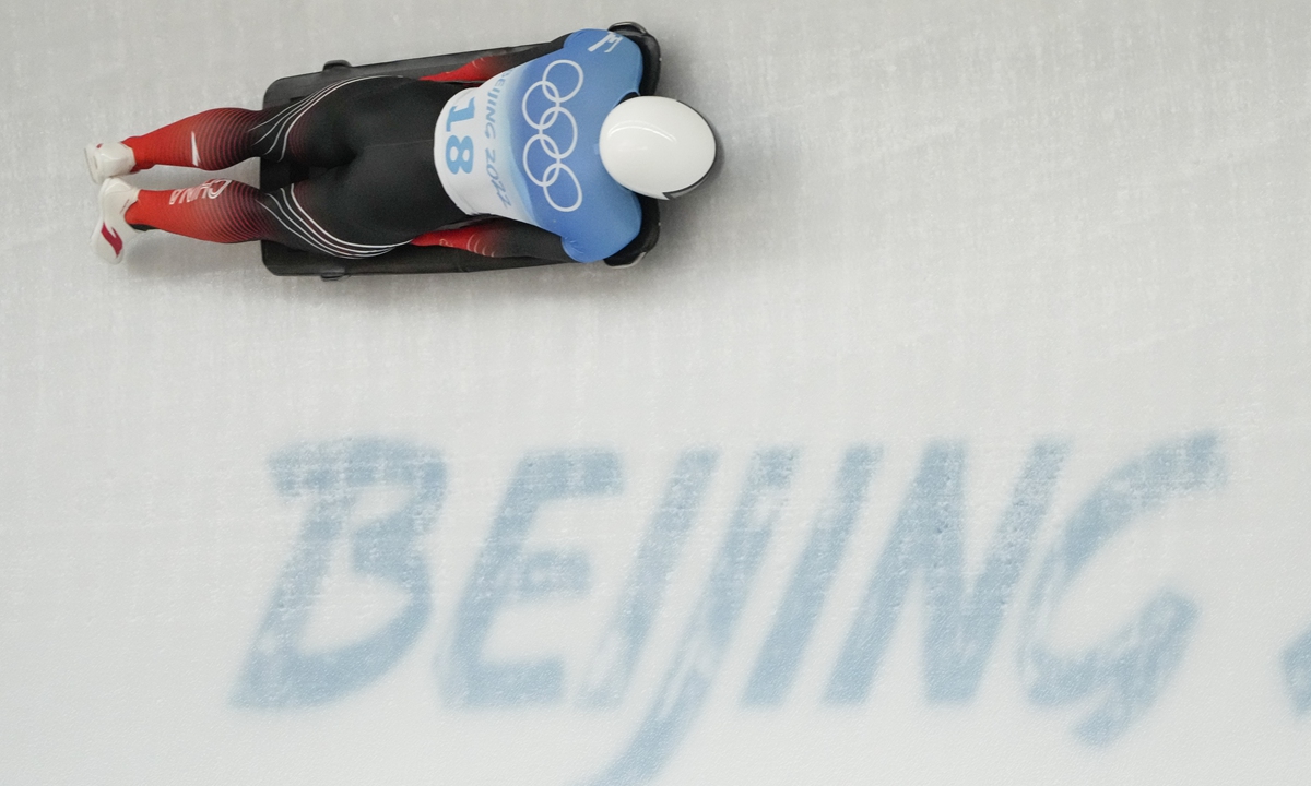 Yan Wengang, of China, slides during men's skeleton run 1 at the 2022 Winter Olympics, on February 10, 2022, in the Yanqing district of Beijing. Photo: VCG