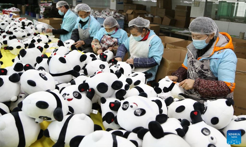 Workers produce Bing Dwen Dwen merchandise at a toy factory in Jinjiang City, southeast China's Fujian Province, Feb. 9, 2022. Bing Dwen Dwen, the mascot for the Beijing 2022 Olympic Winter Games, has recently become a smash hit. A licensed manufacturer in Jinjiang has resumed the production of Bing Dwen Dwen merchandise ahead of schedule to ensure adequate supply for the market.(Photo: Xinhua)