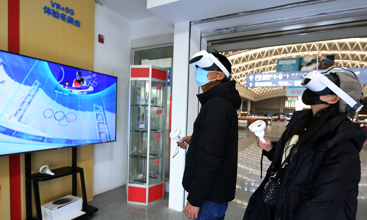 Passengers wearing VR glasses use virtual reality technology to experience the joy of ice and snow sports in the waiting hall of Nanchang railway station in East China's Jiangxi Province on February 11, 2022. Photo: VCG