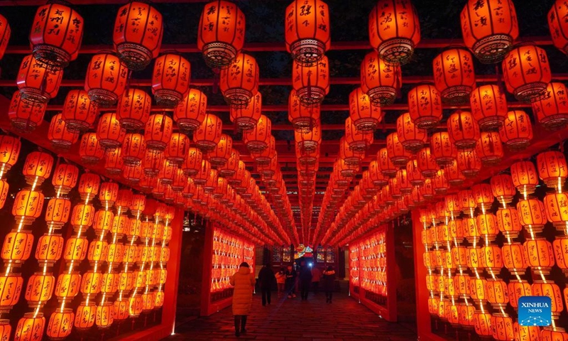 People enjoy the light installations to celebrate the upcoming Latern Festival at the Tengwang Pavilion scenic spot in Nanchang, capital of east China's Jiangxi Province, Feb. 12, 2022. The Lantern Festival, the 15th day of the first month of the Chinese lunar calendar, falls on Feb. 15 this year, which features family reunions, feasts, light shows and various cultural activities. (Xinhua/Wan Xiang)
