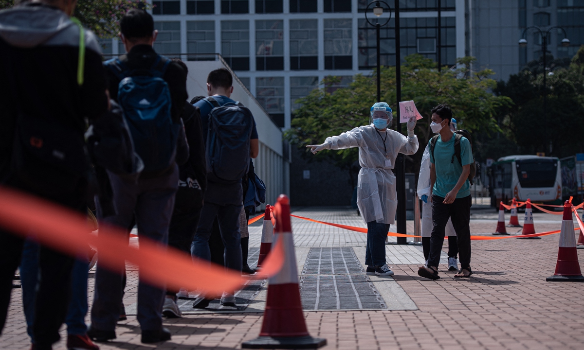 People line up for COVID-19 testing in Hong Kong on February 12, 2022, as city authorities scrambled to ramp up testing capacity following a record high of new infections. Photo: AFP