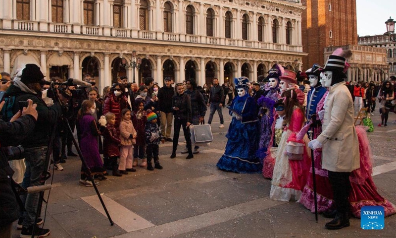 Costumed revelers pose during the Venice Carnival in Venice, Italy, on Feb. 12, 2022.Photo:Xinhua