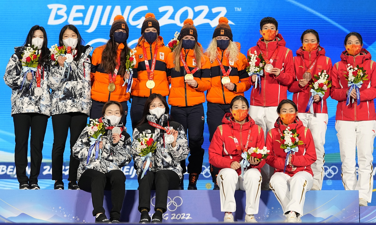 From left, silver medalists team South Korea, gold medalists team Netherlands and bronze medalists team China celebrate during the medal ceremony for the women's 3000-meters short track speedskating relay at the 2022 Winter Olympics on February 14, 2022, in Beijing. Photo: VCG