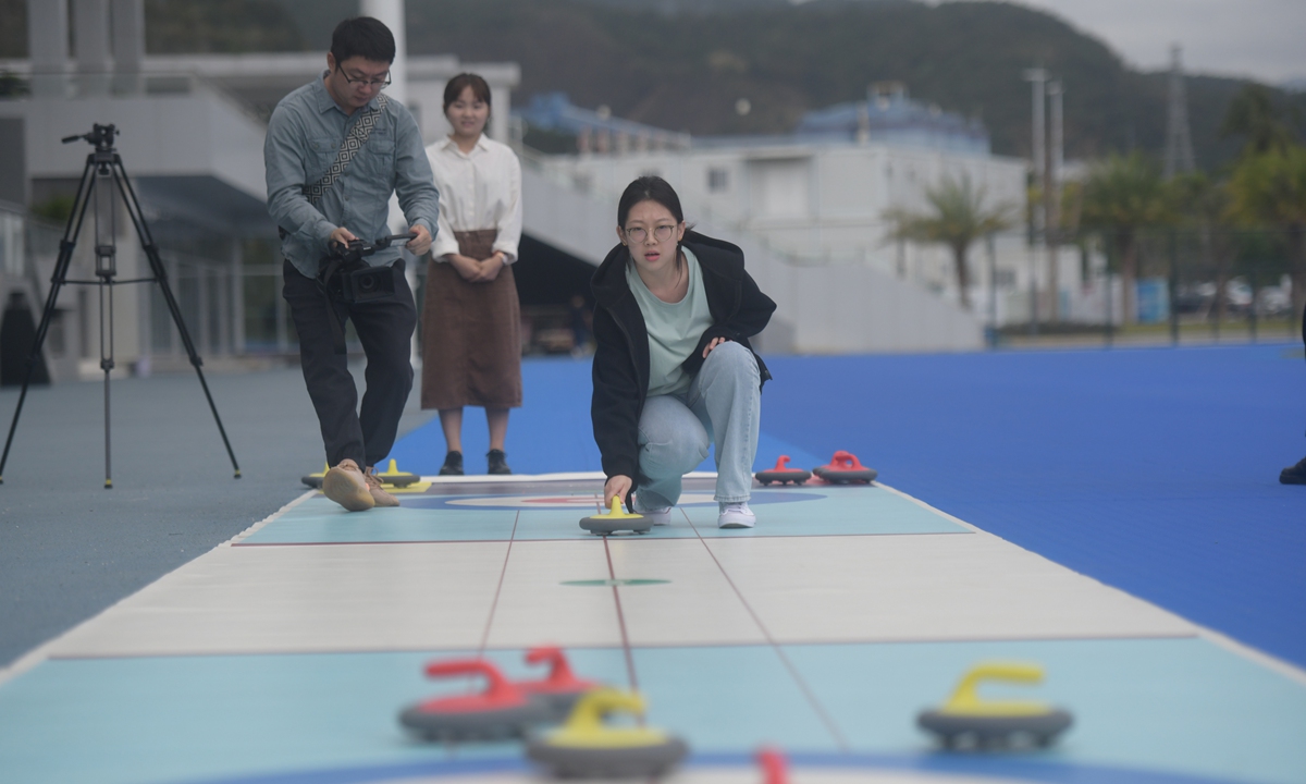Residents in Sanya, South China's Hainan Province, play a game of curling on February 15, 2022 as the Beijing 2022 Winter Olympic Games has brought about the winter sports craze in the country. Photo: VCG