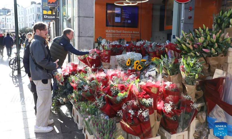 People shop for flowers on Valentine's Day in Dublin, Ireland, on Feb. 14, 2022.(Photo: Xinhua)