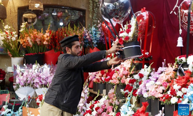 A vendor arranges flowers at a flower shop on Valentine's Day in Islamabad, capital of Pakistan, Feb. 14, 2022.(Photo: Xinhua)