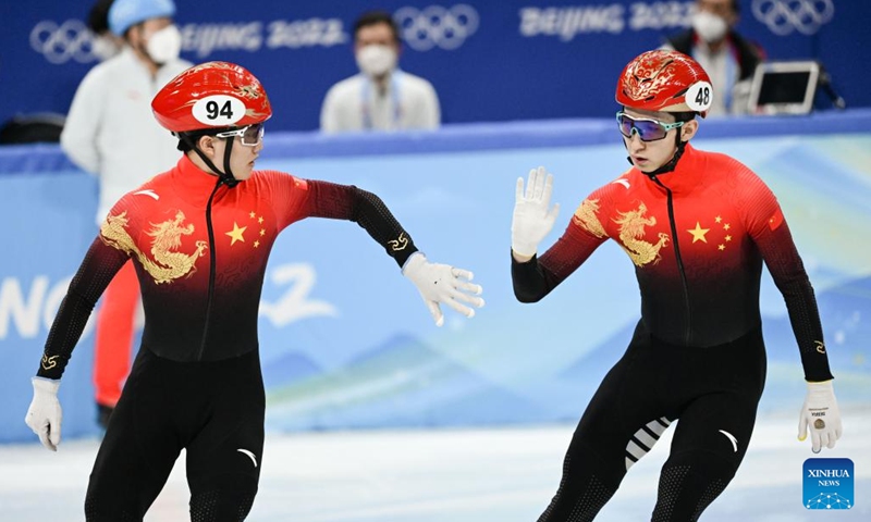 Li Wenlong (left) and Wu Dajing of China react during the men's 5,000m relay final of short track speed skating at Capital Indoor Stadium in Beijing, capital of China, February 16, 2022. Photo: Xinhua/Li Yibo