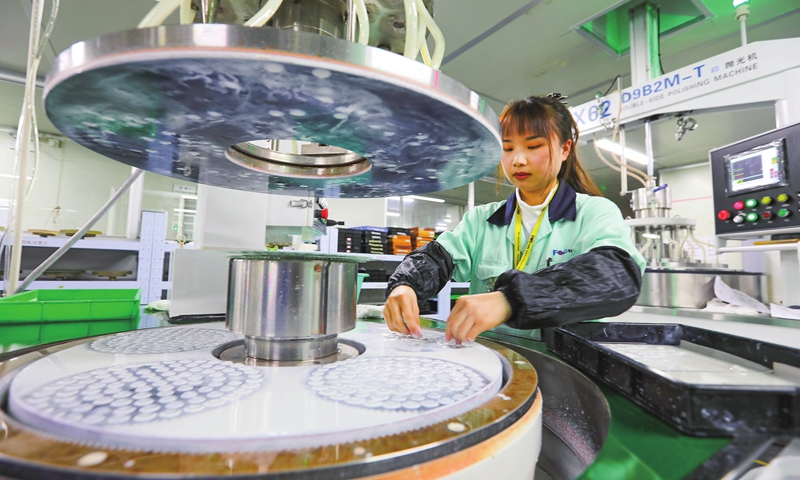 A worker processes precision optical components in Minhou county, Fuzhou, East China's Fujian Province on February 17, 2022. An array of high-tech firms in the county have ramped up sci-tech R&D commitments to boost the appeal of their products, on the premise of effective COVID-19 containment, as they strive for a stellar start to the year. Photo: cnsphoto