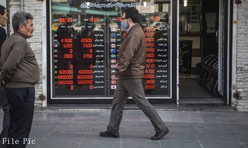 A man walks past a board showing the rates of currencies at a currency exchange center in central Tehran, Iran, Oct. 14, 2020.(Photo: Xinhua)