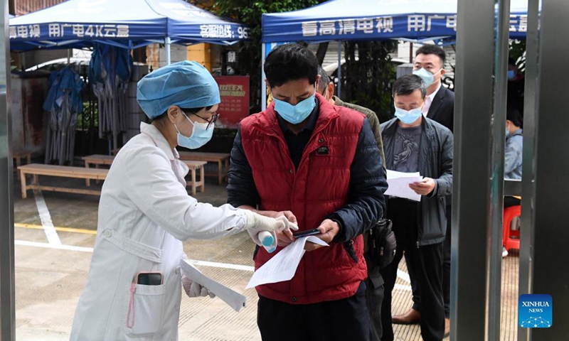 A medical worker checks the information of residents before they get booster shots of the COVID-19 vaccine at a community medical service center in Qingxiu District of Nanning, south China's Guangxi Zhuang Autonomous Region, Nov 2, 2021.Photo:Xinhua