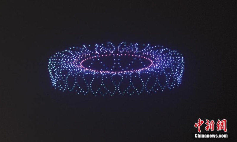 Over 1,000 illuminated drones display the pattern of the main venue of Hangzhou Asia Games in the night sky above the West Lake to welcome the 200-day countdown to the 19th Asia Games in Hangzhou, capital city of east China's Zhejiang Province, Feb. 21,2022. (Photo: China News Service/Wang Gang)