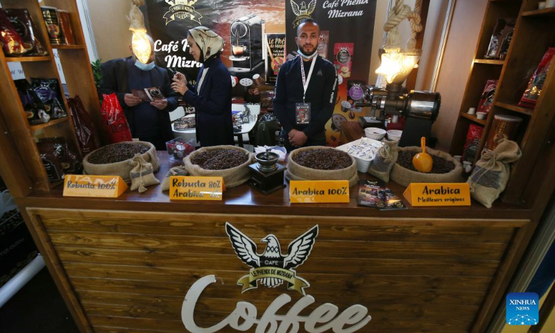 Exhibitors are seen during the Algerian International Fair of Chocolate and Coffee (Chocaf) in Algiers, Algeria, on Feb. 19, 2022. From Feb. 18 to Feb. 21, coffee and chocolate lovers, experts and international producers gather in Algiers to participate in the 5th edition of Chocaf. (Xinhua)