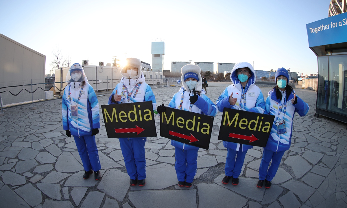 Volunteers guide reporters before the opening ceremony of the Beijing 2022 Winter Olympic Games on February 4 outside the National Stadium in Beijing. Photo: Li Hao/GT