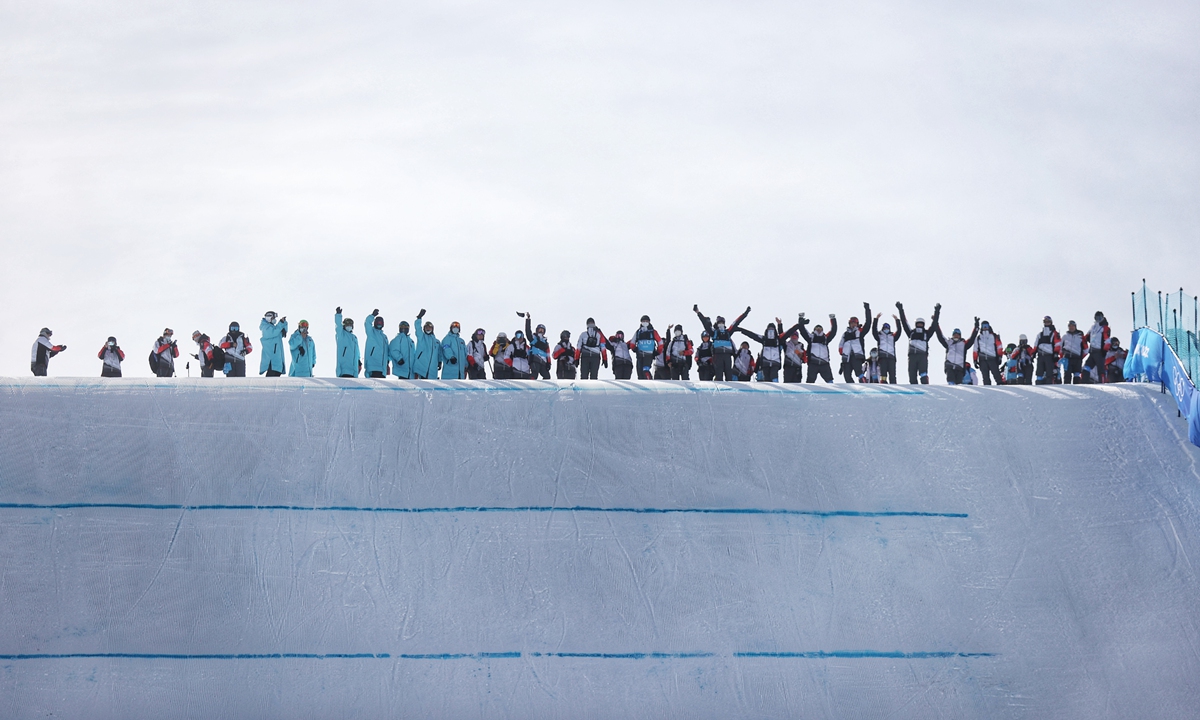 Logistic employees and volunteers celebrate Chinese snowboarder Su Yiming winning the silver medal in the Men's Snowboard Slopestyle on February 7 at Genting Snow Park, Zhangjiakou, North China's Hebei Province. Photo: Cui Meng/GT