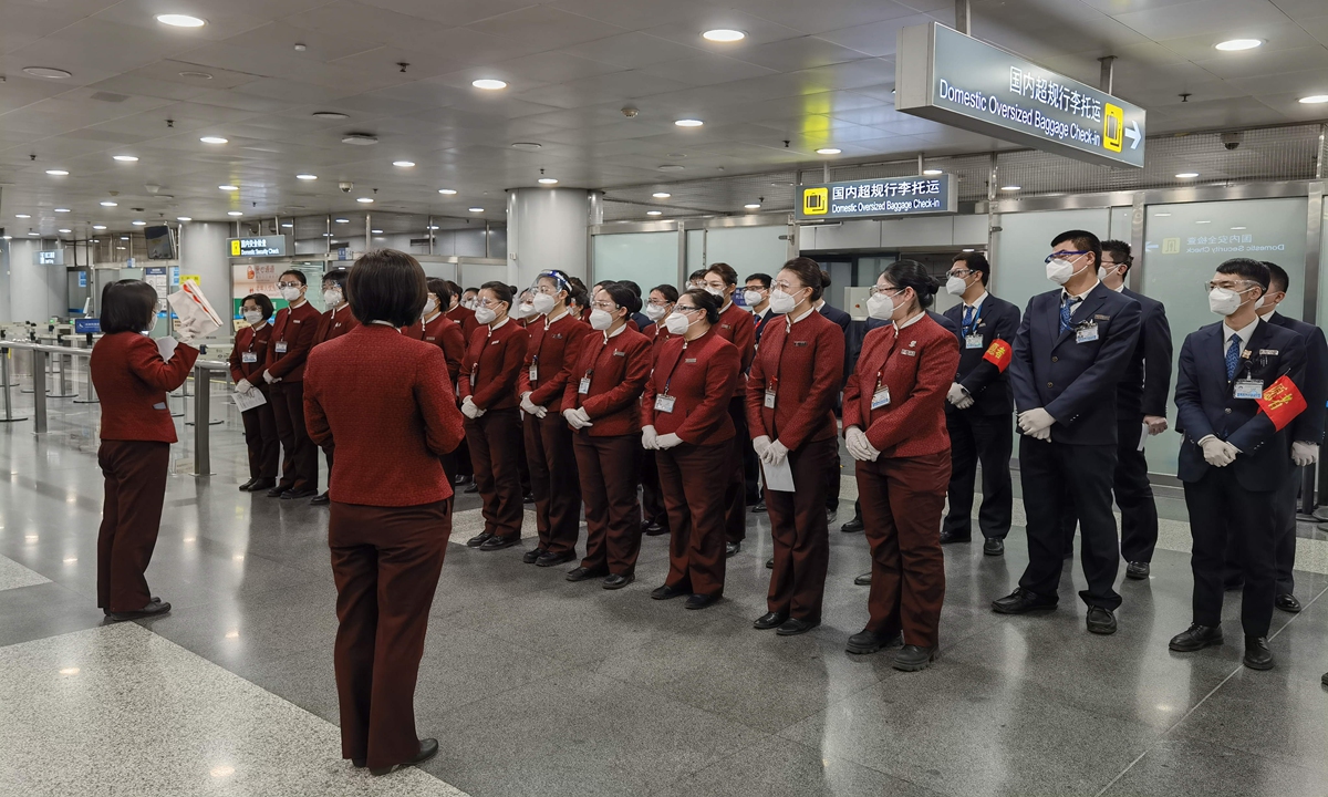 Staff members have a meeting on Sunday morning before the first morning rush hours Photo: Courtesy of Air China


