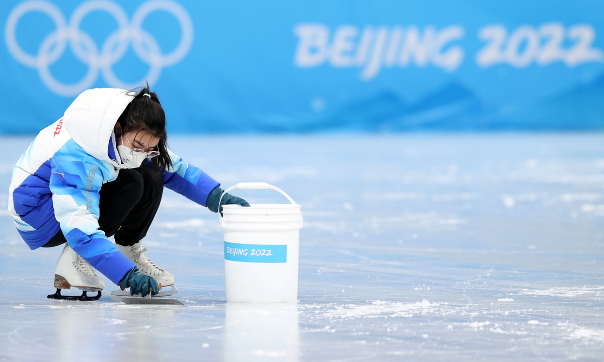 A volunteer prepares the ice prior to the Women's Single Skating Short Program Team Event at Capital Indoor Stadium on February 6, 2022 in Beijing. Photo: VCG