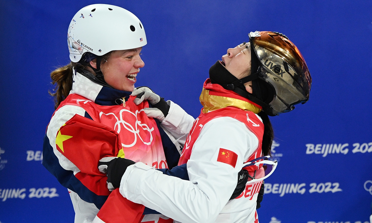 Gold medalist Xu Mengtao (right) of Team China is embraced by Ashley Caldwell of the US during the women's freestyle skiing aerials final at the Beijing Winter Olympics on February 14, 2022. Photo: VCG