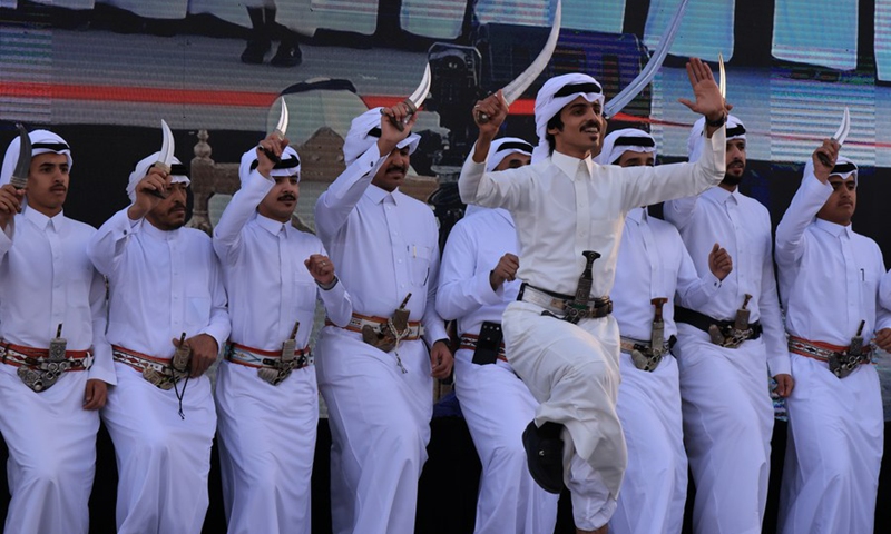 Photo taken on Feb. 22, 2022 shows the Saudi men wearing traditional Arabic robes to perform the traditional dance during the first kingdom's founding day celebration events in High City of Abha, Saudi Arabia.(Photo: Xinhua)