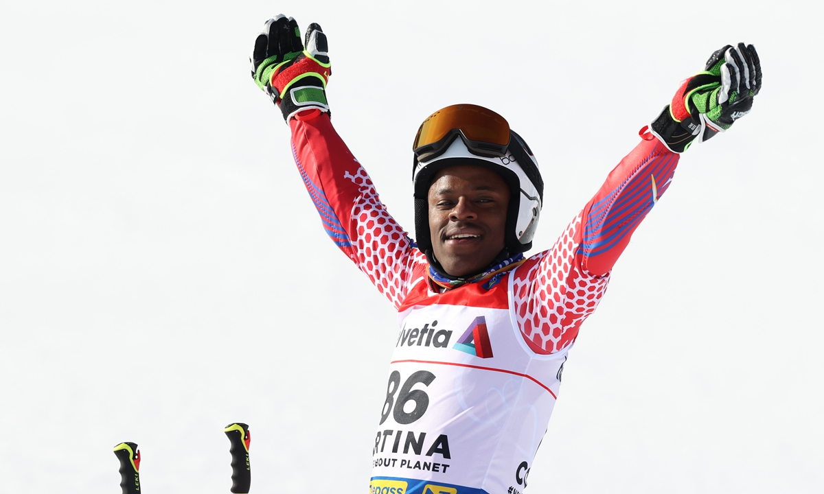 Richardson Viano of Haiti celebrates in the finish area after competing his 2nd run of the FIS World Ski Championships Men's Giant Slalom on February 19, 2021 in Cortina d'Ampezzo, Italy. Photo: VCG