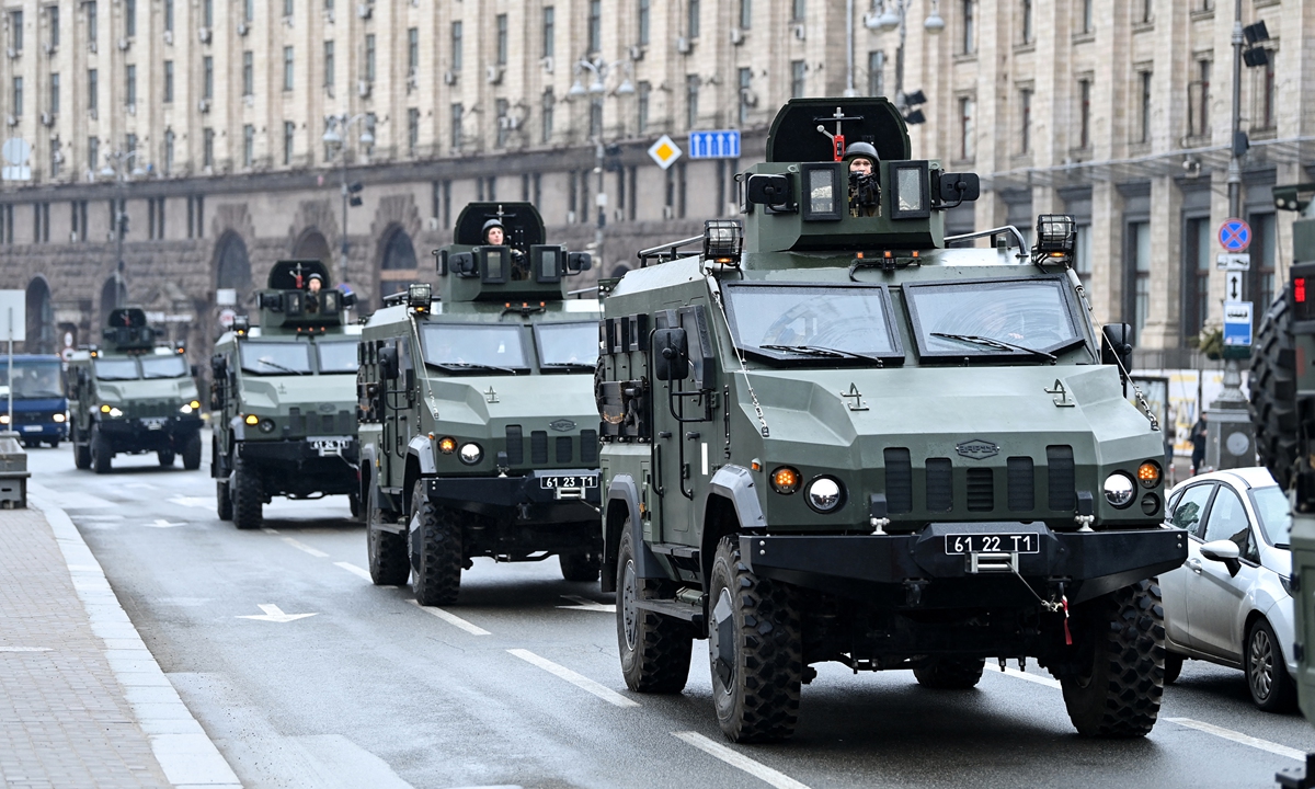 Ukrainian military vehicles move past Independence square in central Kyiv on February 24, 2022. Photo: AFP