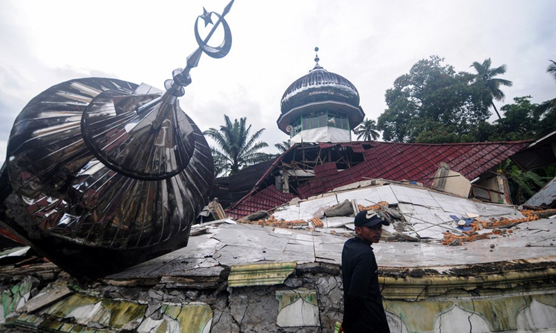 A man stands near a damaged house after an earthquake at Talamau village in Pasaman Barat district, West Sumatra, Indonesia, Feb. 25, 2022.(Photo: Xinhua)