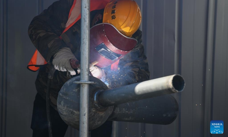 A man works at Zhouliang Station of a railway linking Beijing with the Binhai New Area of Tianjin in north China's Tianjin, Feb. 26, 2022. With a length of about 172 kilometers and a designed speed of 350 kilometers per hour, the second intercity express railway linking Beijing with the Binhai New Area of Tianjin is expected to cut travel time between the two areas to 57 minutes. (Xinhua/Sun Fanyue)