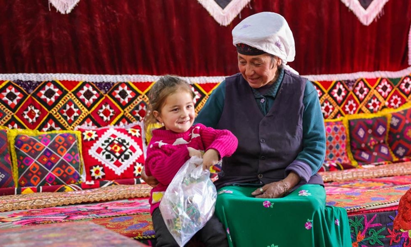 A child chats with her family at home in Rasekam Village of Taxkorgan Tajik Autonomous County, northwest China's Xinjiang Uygur Autonomous Region, Feb. 24, 2022.Photo:Xinhua