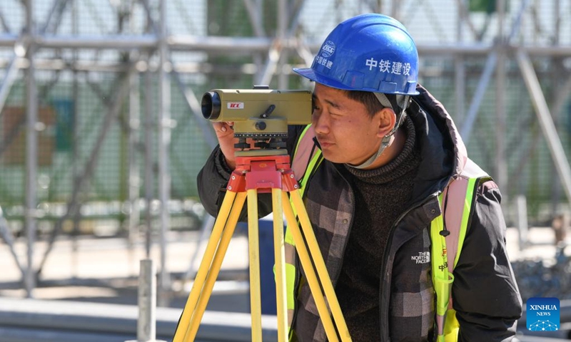 A man works at Zhouliang Station of a railway linking Beijing with the Binhai New Area of Tianjin in north China's Tianjin, Feb. 26, 2022. With a length of about 172 kilometers and a designed speed of 350 kilometers per hour, the second intercity express railway linking Beijing with the Binhai New Area of Tianjin is expected to cut travel time between the two areas to 57 minutes. (Xinhua/Sun Fanyue)