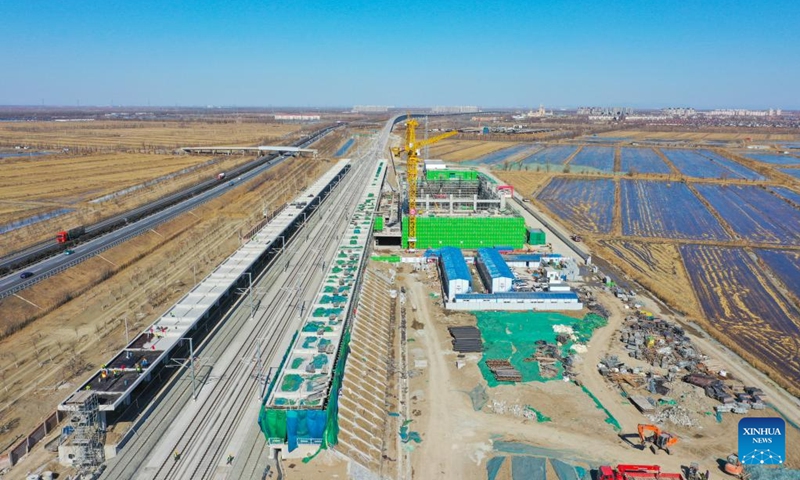 Aerial photo shows Zhouliang Station of a railway linking Beijing with the Binhai New Area of Tianjin in north China's Tianjin, Feb. 26, 2022. With a length of about 172 kilometers and a designed speed of 350 kilometers per hour, the second intercity express railway linking Beijing with the Binhai New Area of Tianjin is expected to cut travel time between the two areas to 57 minutes. (Xinhua/Sun Fanyue)