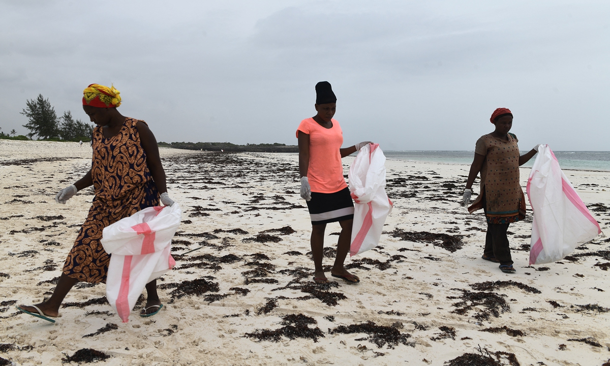 Volunteers collect plastic waste during a cleaning campaign organized by Ocean Sole Africa in Kilifi county, Kenya on February 12, 2022. Photo: AFP