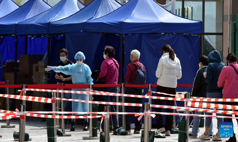 People queue up for COVID-19 tests at Tsing Yi mobile test site in Hong Kong, south China, Feb. 27, 2022. Hong Kong reported 26,026 new COVID-19 cases on Sunday, official data showed. (Xinhua/Lo Ping Fai)