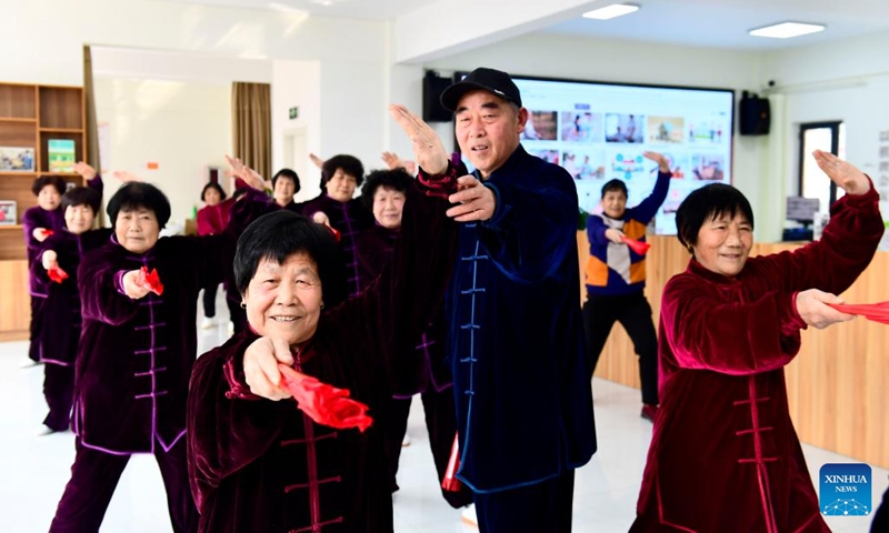 Elderly people practice Taiji at a community care center for the elderly in Lanshan District, Rizhao, east China's Shandong Province, Feb. 27, 2022. Lanshan District of Rizhao City has set up care centers since 2021, providing assistance and care to the elderly people over 60 years old.(Photo: Xinhua)