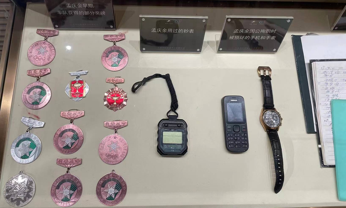 Medals, stopwatches, mobile phones, and a watch belonging to Meng Qingyu on display at Qitaihe Short Track Speed Skating Championship Hall. Photo: Wang Qi/GT