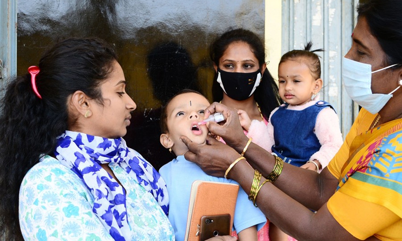 An Indian medical volunteer administers a dose of polio vaccine to a child as part of the Indian National Pulse Polio Immunisation Programme in Bangalore, India, Sunday, Feb. 27, 2022.(Photo: Xinhua)