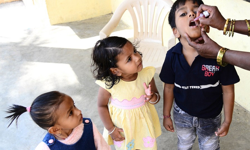An Indian medical volunteer administers a dose of polio vaccine to a child as part of the Indian National Pulse Polio Immunisation Programme in Bangalore, India, Feb. 27, 2022.(Photo: Xinhua)