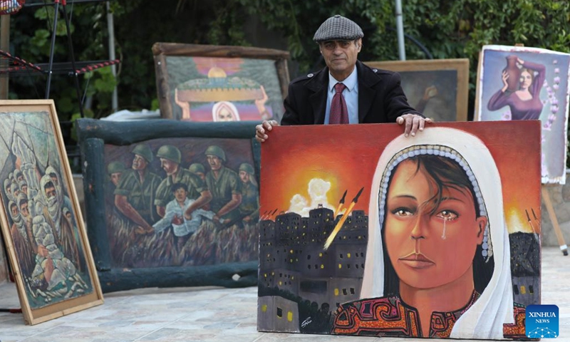 Murshid Gharib, a 73-year-old painter from Jenin who has about 50 years of experience in painting murals, works on a painting at his house in the West Bank city of Jenin, Feb. 21, 2022. TO GO WITH Feature: Palestine artists turn walls into canvas for hope(Photo: Xinhua)