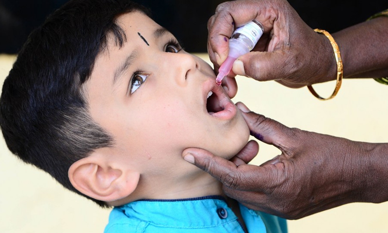 An Indian medical volunteer administers a dose of polio vaccine to a child as part of the Indian National Pulse Polio Immunisation Programme in Bangalore, India, Feb. 27, 2022.(Photo: Xinhua)
