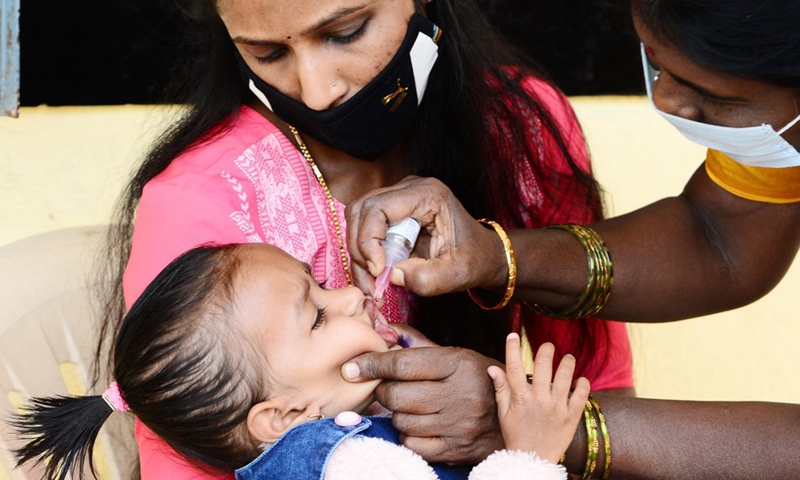 An Indian medical volunteer administers a dose of polio vaccine to a child as part of the Indian National Pulse Polio Immunisation Programme in Bangalore, India, Feb. 27, 2022.(Photo: Xinhua)