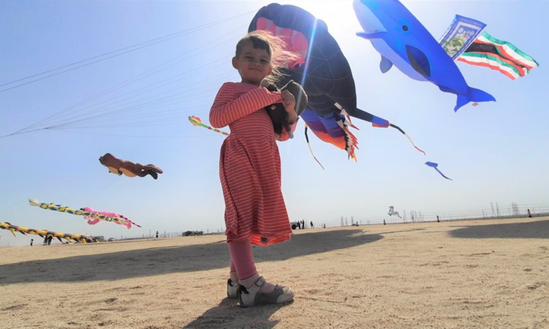 A child watches kites during national holidays in Ahmadi Governorate, Kuwait, on March 2, 2022.(Photo: Xinhua)