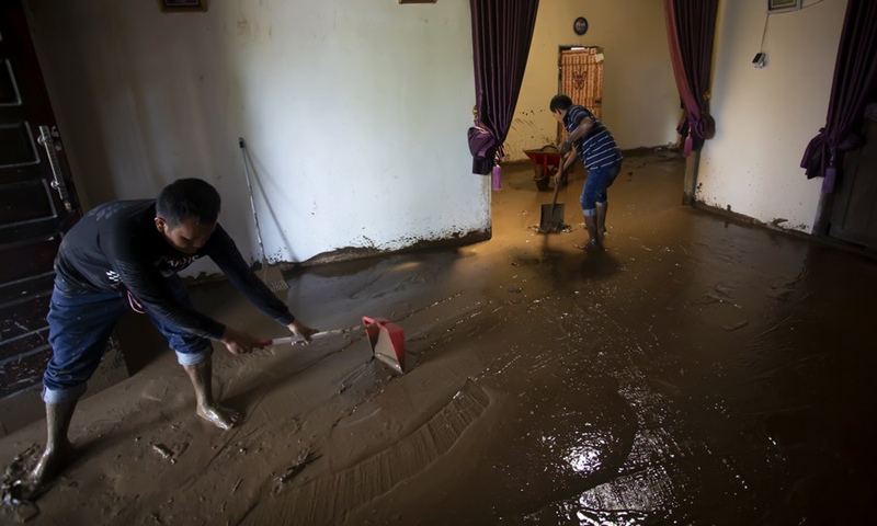 People clean mud at their house after floods triggered by heavy rains and rising waters of the Batang Nango river in Nagari Kajai village of Pasaman Barat district, West Sumatra, Indonesia, March 1, 2022.(Photo: Xinhua)