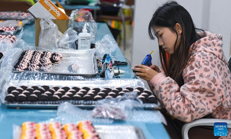 Workers assemble Tang dolls at a workshop in Huishui County of Qiannan Buyi and Miao Autonomous Prefecture, southwest China's Guizhou Province, March 1, 2022.Photo:Xinhua