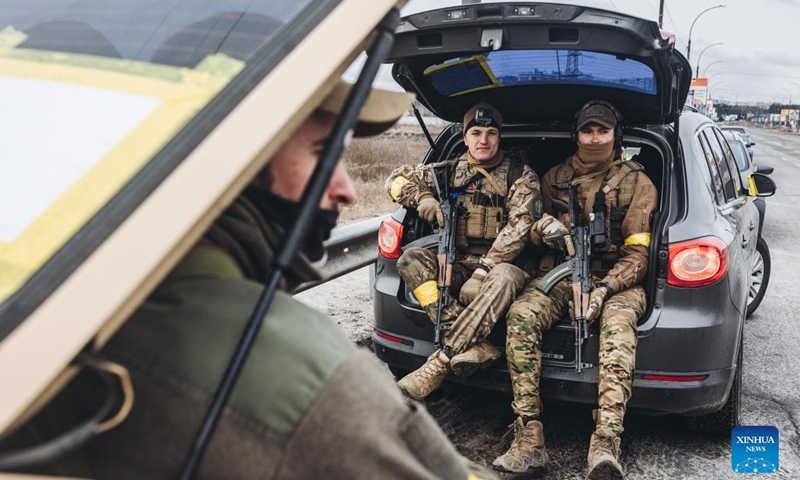 Ukrainian soldiers rest on a car in Irpin, Ukraine, on March 4, 2022.Photo:Xinhua