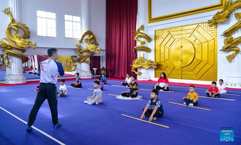 Gogi Nebulana (front), founder and martial arts coach of Harmony Wushu Indonesia, teaches children to practice martial arts at Harmony Wushu Indonesia in Bogor, Indonesia, March 5, 2022.Photo:Xinhua