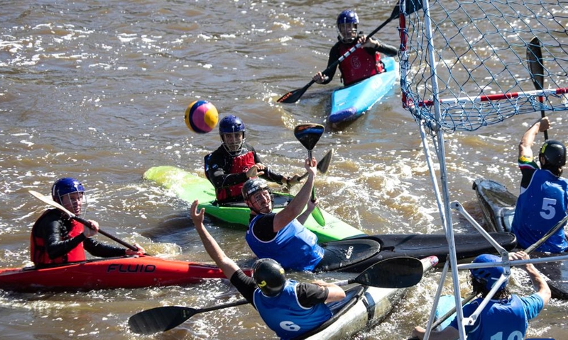 Paddlers compete in a canoe polo match during Century City Sports Festival in Cape Town, legislative capital of South Africa, on March 5, 2022.Photo:Xinhua