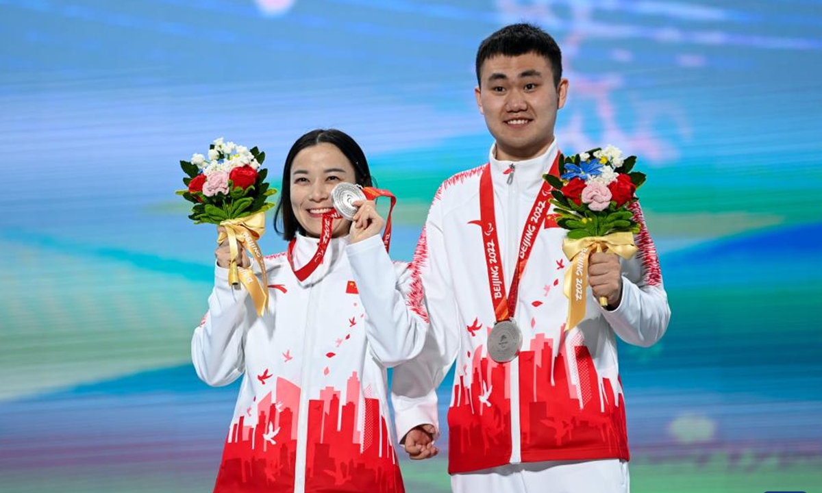 Chinese skier Zhu Daqing (left) and her guide Yan Hanhan pose for photo during the awarding ceremony for the para alpine skiing women's Downhill Vision Impaired of Beijing 2022 Paralympic Winter Games at Yanqing Medals Plaza of the Winter Paralympics in Yanqing District, Beijing, capital of China, March. 5, 2022.Photo: Xinhua News Agency