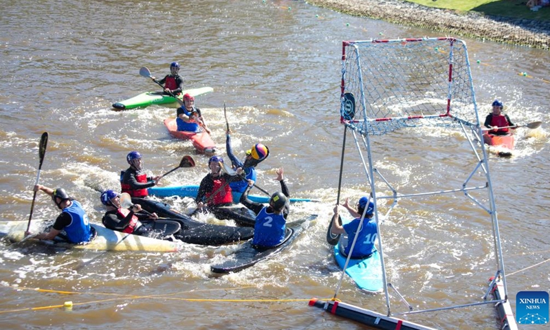 Paddlers compete in a canoe polo match during Century City Sports Festival in Cape Town, legislative capital of South Africa, on March 5, 2022.Photo:Xinhua